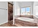 Bright bathroom showcases a tiled shower and separate soaking tub beneath a large window at 4669 E Olney Ave, Gilbert, AZ 85234