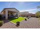 View of backyard with gravel, artificial turf, and covered patio with lounge seating at 5844 S Tobin --, Mesa, AZ 85212