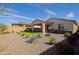 View of the backyard featuring a covered patio, artificial turf, and desert landscaping at 5844 S Tobin --, Mesa, AZ 85212