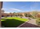 Wide view of backyard features an artificial turf patch with desert landscaping at 5844 S Tobin --, Mesa, AZ 85212