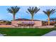 Community entrance sign with 'encore' lettering with palm trees and green lawn at 5844 S Tobin --, Mesa, AZ 85212