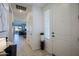 Inviting entryway with tile flooring, a white front door, and a view into a brightly lit living area at 5844 S Tobin --, Mesa, AZ 85212