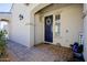 Inviting entryway featuring a navy blue front door adorned with a wreath, set in a neutral-toned facade at 5844 S Tobin --, Mesa, AZ 85212