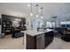 Well-lit kitchen view features granite counters, a dark wood kitchen island, and a sink at 5844 S Tobin --, Mesa, AZ 85212