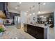 Kitchen close-up, granite counters, dark wood cabinets, gas range, and stainless fridge with built-in water and ice dispenser at 5844 S Tobin --, Mesa, AZ 85212