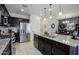 Kitchen with stainless steel refrigerator, granite counters, a large island with sink, and dark wood cabinets at 5844 S Tobin --, Mesa, AZ 85212