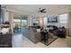 Bright living room featuring a gray sofa, large windows and sliding doors to a patio at 5844 S Tobin --, Mesa, AZ 85212