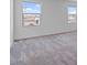 Bright bedroom featuring soft carpet and natural light from windows at 618 E Elm Ln, Avondale, AZ 85323