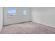 Bright bedroom with soft carpet and natural light from two windows at 618 E Elm Ln, Avondale, AZ 85323