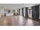 Open-concept living space with wood-look floors, leading to sliding doors, and adjacent to a modern kitchen at 618 E Elm Ln, Avondale, AZ 85323