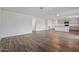 Spacious living area featuring wood-style floors and an open layout leading into the kitchen at 618 E Elm Ln, Avondale, AZ 85323