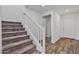 A staircase with carpeted steps and white railing leads to the upper level of the home at 618 E Elm Ln, Avondale, AZ 85323