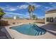 Serene backyard with a spacious pool, bordered by desert landscaping and palm trees at 630 W Madero Ave, Mesa, AZ 85210