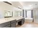 Elegant primary bathroom with dual vanities, soaking tub, and glass-enclosed shower at 630 W Madero Ave, Mesa, AZ 85210