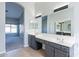 Well-lit primary bathroom with dual sinks, a large mirror, and vanity seating at 630 W Madero Ave, Mesa, AZ 85210