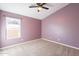 Bedroom with neutral carpet, lavender walls and a window offering natural light at 630 W Madero Ave, Mesa, AZ 85210