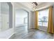 Bright dining room with wood floors, archways and natural light from the large window at 630 W Madero Ave, Mesa, AZ 85210