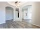 Spacious dining room with decorative archways and a modern chandelier with wooden floors at 630 W Madero Ave, Mesa, AZ 85210