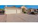 Charming home with a spacious three-car garage and a well-maintained driveway, showcasing curb appeal at 630 W Madero Ave, Mesa, AZ 85210