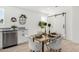 Bright dining area featuring a modern table setting and sleek cabinets with sliding barn door access at 645 N 97Th St, Mesa, AZ 85207