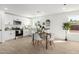 Bright kitchen and dining area featuring stainless steel appliances, white cabinetry, and stylish flooring at 645 N 97Th St, Mesa, AZ 85207