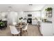 Modern kitchen and dining space featuring granite countertops, stainless steel appliances, and wood look tile flooring at 645 N 97Th St, Mesa, AZ 85207