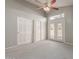 Light-filled bedroom featuring large closets, neutral carpet, and a private entrance at 6834 S Dennis Dr, Tempe, AZ 85283