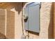 A home's exterior featuring a gray electrical box, showcasing the house's electrical system at 6834 S Dennis Dr, Tempe, AZ 85283