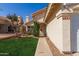 Inviting home entrance with desert landscaping, walkway and ample lawn space at 6834 S Dennis Dr, Tempe, AZ 85283