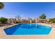 Inviting community pool with lounge chairs and pergolas provides ample relaxation space at 6834 S Dennis Dr, Tempe, AZ 85283