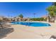 Community pool with lounge chairs and shade structure creates a relaxing atmosphere at 6834 S Dennis Dr, Tempe, AZ 85283