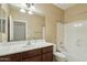 Bathroom with a bathtub, dark wood vanity, a mirror, and tile flooring at 7355 W Red Hawk Dr, Peoria, AZ 85383