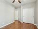 Bedroom with hardwood floors, a ceiling fan, closet with sliding doors, and a view of the hallway at 7355 W Red Hawk Dr, Peoria, AZ 85383