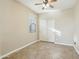 Comfortable bedroom with neutral tones, tile flooring, and a closet for organized living at 7355 W Red Hawk Dr, Peoria, AZ 85383