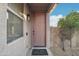 Inviting front entrance with a classic door, decorative light fixture, and manicured landscaping at 7355 W Red Hawk Dr, Peoria, AZ 85383