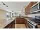 Modern kitchen featuring stainless steel appliances, granite counters, tile flooring, and an open layout at 7355 W Red Hawk Dr, Peoria, AZ 85383