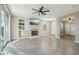 Cozy living room with tile flooring, a fireplace, a ceiling fan, and media console at 7355 W Red Hawk Dr, Peoria, AZ 85383