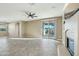 Bright and airy living room with sliding glass doors, tile flooring, ceiling fan and fireplace at 7355 W Red Hawk Dr, Peoria, AZ 85383