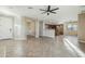 Open-concept living area with tile floors, neutral walls, and seamless flow into the kitchen at 7355 W Red Hawk Dr, Peoria, AZ 85383