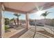 Relaxing covered patio, featuring views of the pool and landscaping, perfect for outdoor entertainment at 7355 W Red Hawk Dr, Peoria, AZ 85383