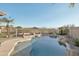 Inviting pool with rock features and desert views, perfect for relaxation and entertaining in the Arizona sun at 7355 W Red Hawk Dr, Peoria, AZ 85383