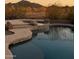 Inviting backyard pool and spa with stone accents offer a serene oasis for relaxation and recreation at 7355 W Red Hawk Dr, Peoria, AZ 85383