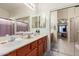 Bright bathroom with dual sinks, generous counter space and access to the bedroom at 8029 W Whyman Ave, Phoenix, AZ 85043