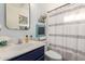 Charming bathroom with a stylish vanity, decorative mirror, and shower with curtain at 8029 W Whyman Ave, Phoenix, AZ 85043