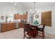 Cozy kitchen area featuring a breakfast table, stainless steel appliances, and wooden cabinets at 8029 W Whyman Ave, Phoenix, AZ 85043