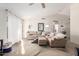 Bright living room with high vaulted ceiling, modern flooring, large sectional sofa, and natural light at 8029 W Whyman Ave, Phoenix, AZ 85043