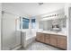 Bright bathroom with double sinks, soaking tub, glass enclosed shower, and neutral finishes at 827 W Kesler Ln, Chandler, AZ 85225