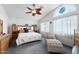 Spacious bedroom featuring a vaulted ceiling, ceiling fan, and a unique window at 827 W Kesler Ln, Chandler, AZ 85225