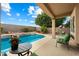 Relaxing backyard pool featuring beautiful landscaping, patio seating and a clear blue sky at 827 W Kesler Ln, Chandler, AZ 85225