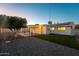 Inviting backyard featuring a covered patio, synthetic grass, mature trees, and pristine landscaping at 8443 E Sheridan St, Scottsdale, AZ 85257